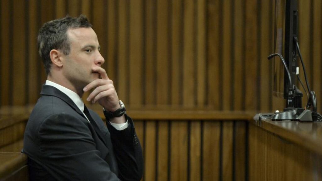 South African Paralympic champion Oscar Pistorius sits in the courtroom during his trial. Photograph: Herman Verwey/EPA