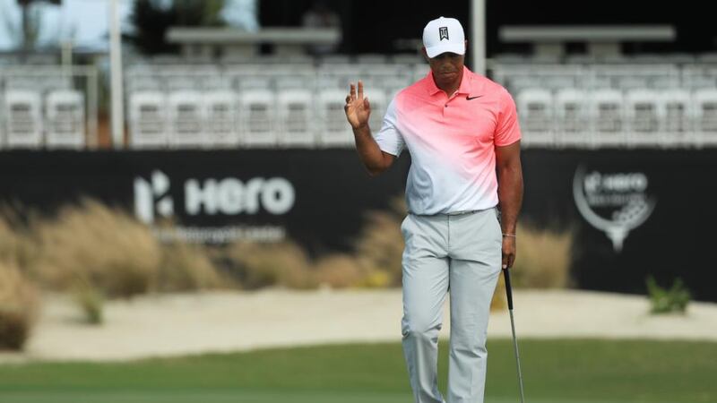 Woods acknowledges the small gallery after holing an eagle putt. Photo: Mike Ehrmann/Getty Images