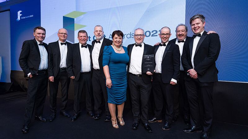 Cathal McGuinness, director at SAS International, presents the fit out project of the year award to JCA Architects team