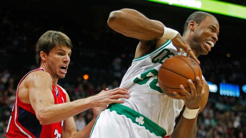 Boston Celtics’ center Jason Collins grabs a rebound away from Atlanta Hawks guard Kyle Korver
