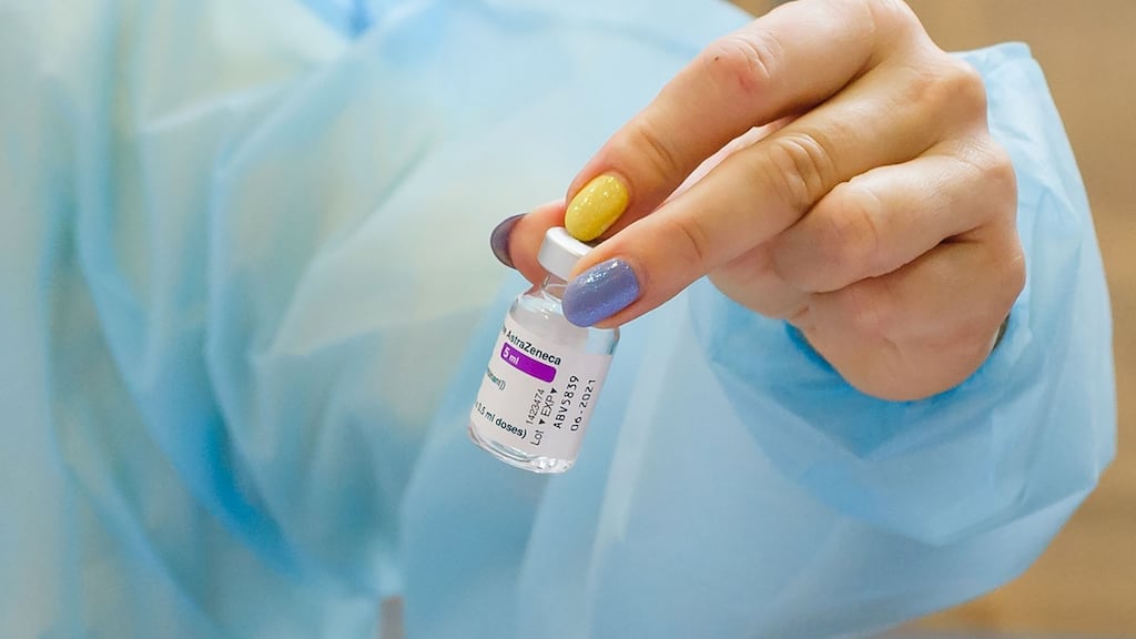 A medical worker holds a vial of the AstraZeneca vaccine. Photograph: Gints Ivuskans/AFP via Getty Images