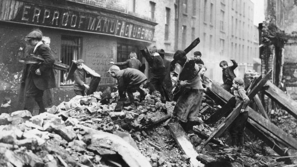 Children gather firewood from the remains of buildings destroyed in Dublin in the Easter Rising of 1916. Broadcaster Joe Duffy is to publish a book on children killed during the fighting. File photograph: Central Press/Getty Images