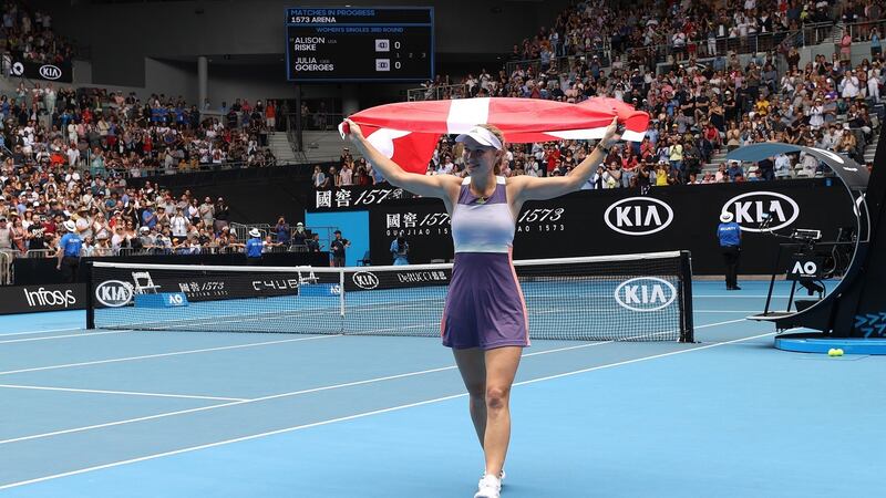 Caroline Wozniacki drapes a Danish flag over her shoulders and acknowledges the crowd after losing her Women’s Singles third round match against Ons Jabeur on day five of the 2020 Australian Open at Melbourne Park. Photo: Clive Brunskill/Getty Images