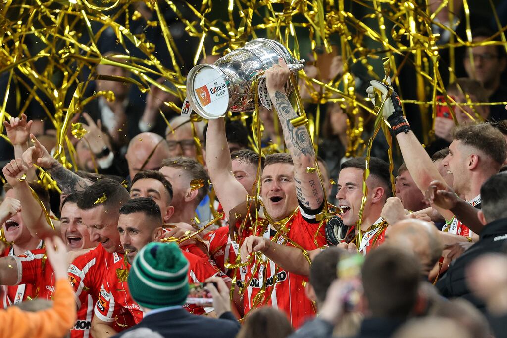 Derry City's Patrick McEleney lifts the FAI Cup trophy after the victory over Shelbourne at the Aviva Stadium in November 2022. Photograph: Bryan Keane/Inpho
