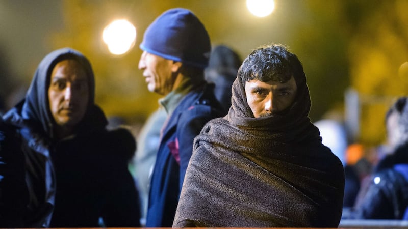 Migrants wait to board buses to be transfered to Austrian refugee centres on Saturday on the Austrian side of the border crossing between Sentilj (Slovenia) and Spielfeld. Photograph: Jure Makovec/AFP/Getty Images