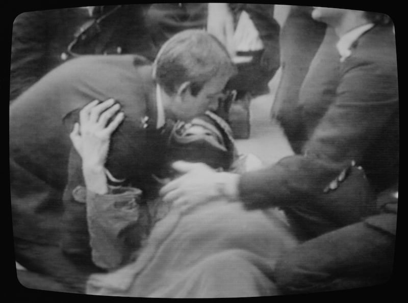 A television screen showing news footage of police attending to a wounded demonstrator outside the Libyan embassy on St James's Square, London, April 17th, 1984. Photograph: Daily Express/Hulton Archive/Getty