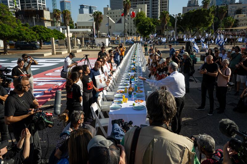 Families of hostages held by Hamas in the Gaza Strip participate in a Kabalat Shabbat (welcoming the Shabbat) prayer service on Friday next to a 'Shabbat Dinner' table set up in the Tel Aviv museum plaza, with 200 empty seats representing the hostages and missing people, in Tel Aviv, Israel. Photograph: Alexi J Rosenfeld/Getty