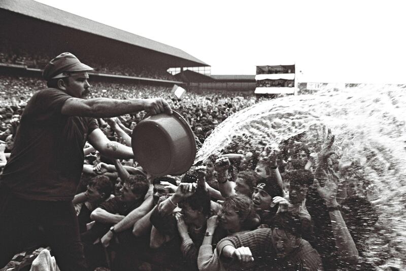 Scorching performance: throwing basins of water over fans to keep them cool when U2 performed The Joshua Tree at Croke Park, Dublin, the first time around, in 1987. Photograph: Eric Luke