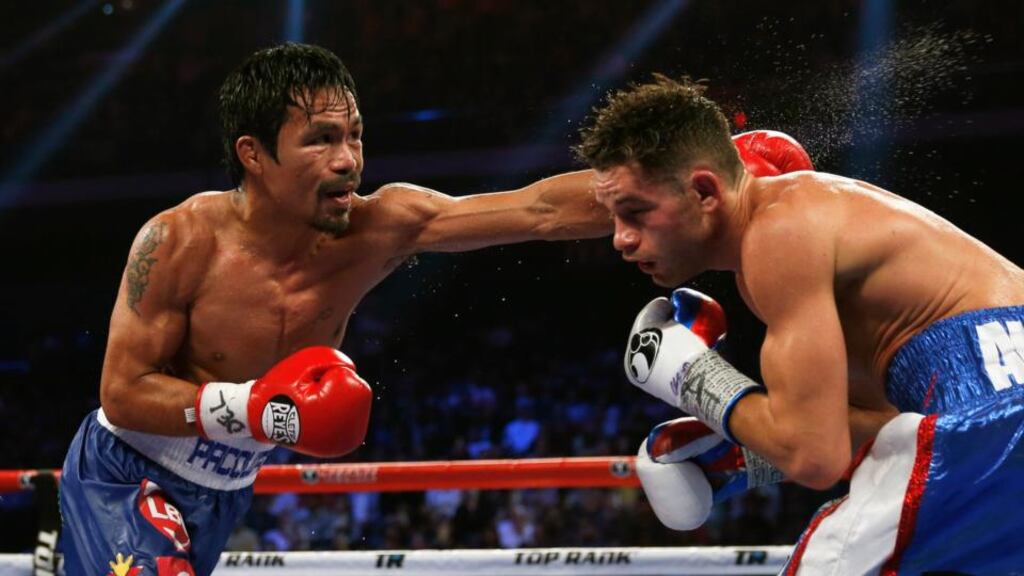 Manny Pacquiao (left) of the Philippines punches Chris Algieri of the US during their World Boxing Organisation (WBO) 12-round welterweight title fight at the Venetian Macao Hotel in Macau. Photograph: Tyrone Siu / Reuters