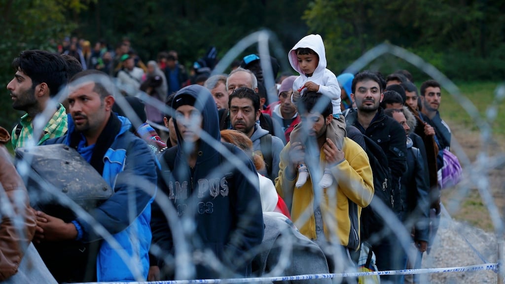 Migrants make their way after crossing the border at Zakany, Hungary. Photograph: Laszlo Balogh/Reuters
