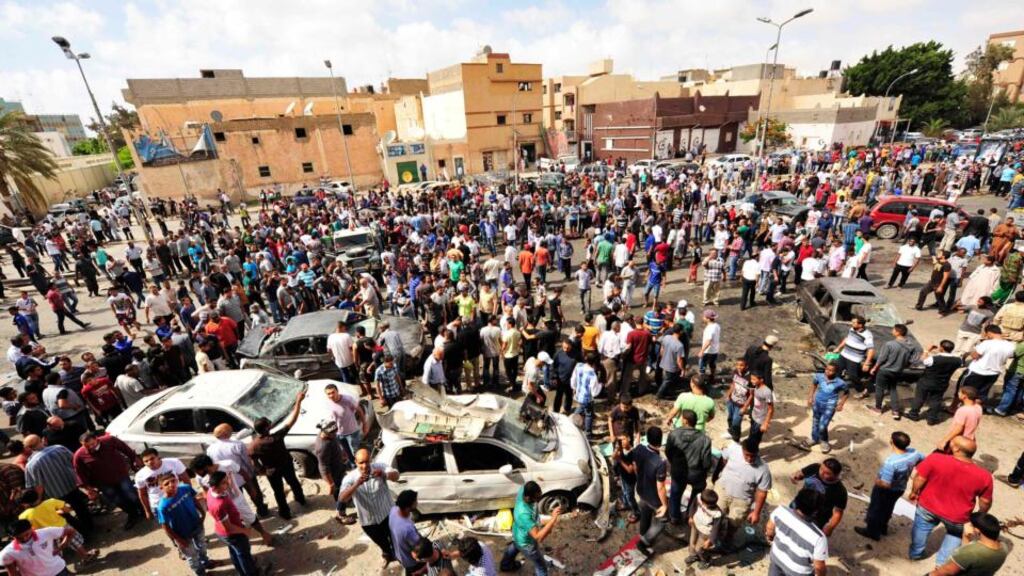 People gather at the scene of a car bomb explosion outside a hospital in Benghazi, where three people were killed on Monday. Photograph: Esam Al-Fetori/Reuters