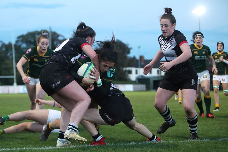 Railway Union's Amee-Leigh Murphy Crowe scores a try at Park Avenue on Saturday despite the efforts of Claire McGowan and Kelly McCormill of Cooke. Photograph: Bryan Keane/Inpho