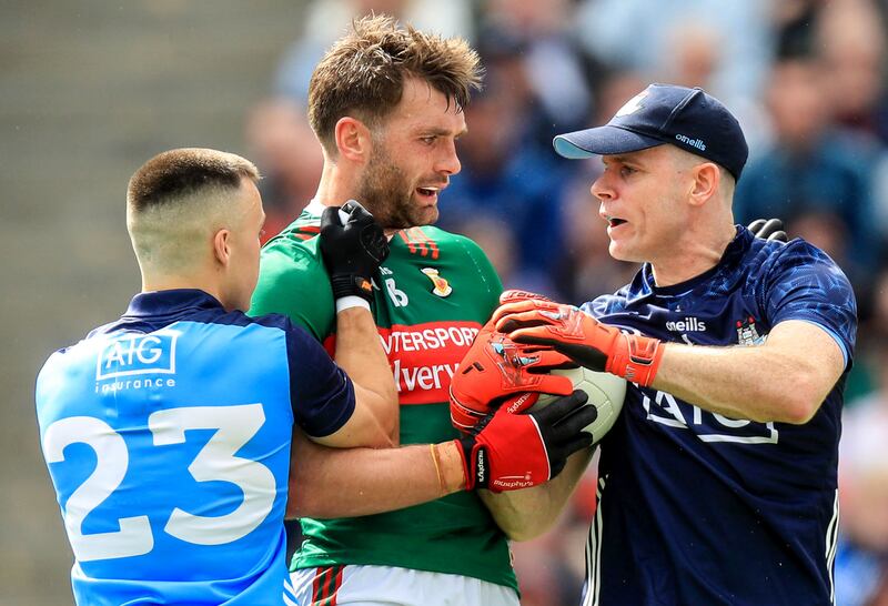 Tempers flare between Mayo's Aidan O'Shea (centre) and Dublin goalkeeper Stephen Cluxton (right) during the 2023 All-Ireland SFC quarter-final. Photograph: Evan Treacy/Inpho