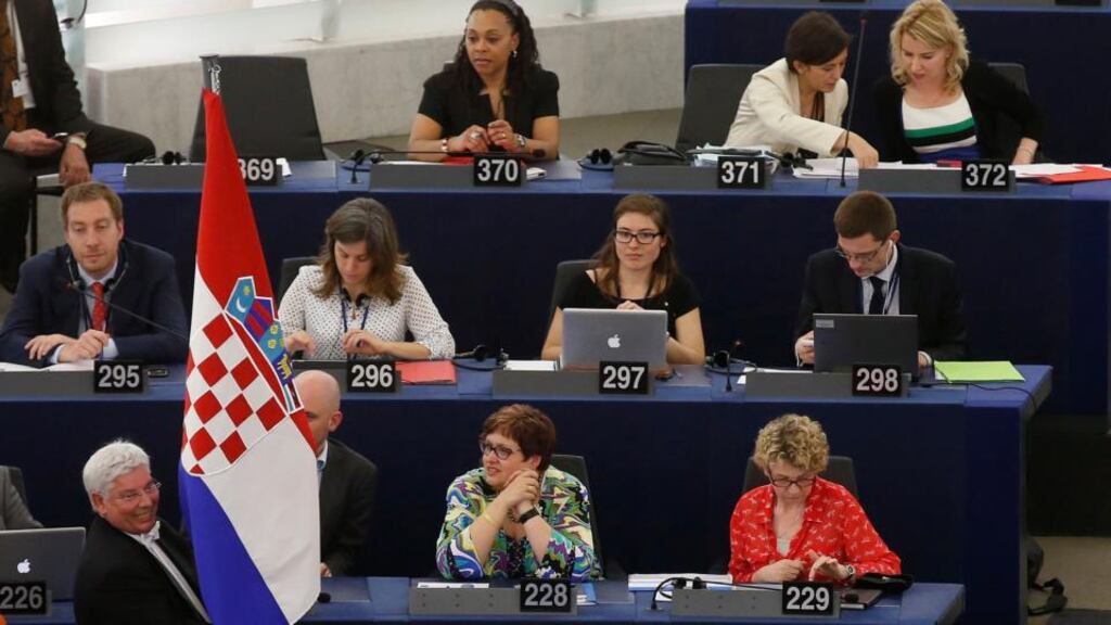 An usher of the European Parliament holds the flag of Croatia during a ceremony marking the start of Croatia’s membership to the EU, at the European Parliament in Strasbourg on Monday. Photograph: Vincent Kessler/Reuters