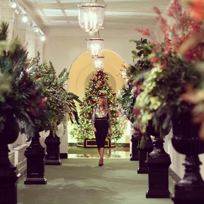 Melania Trump in the East Colonnade of the White House, where the decorations feature simple black urns holding plumes of foliage and greenery from each state and territory. Photograph: White House