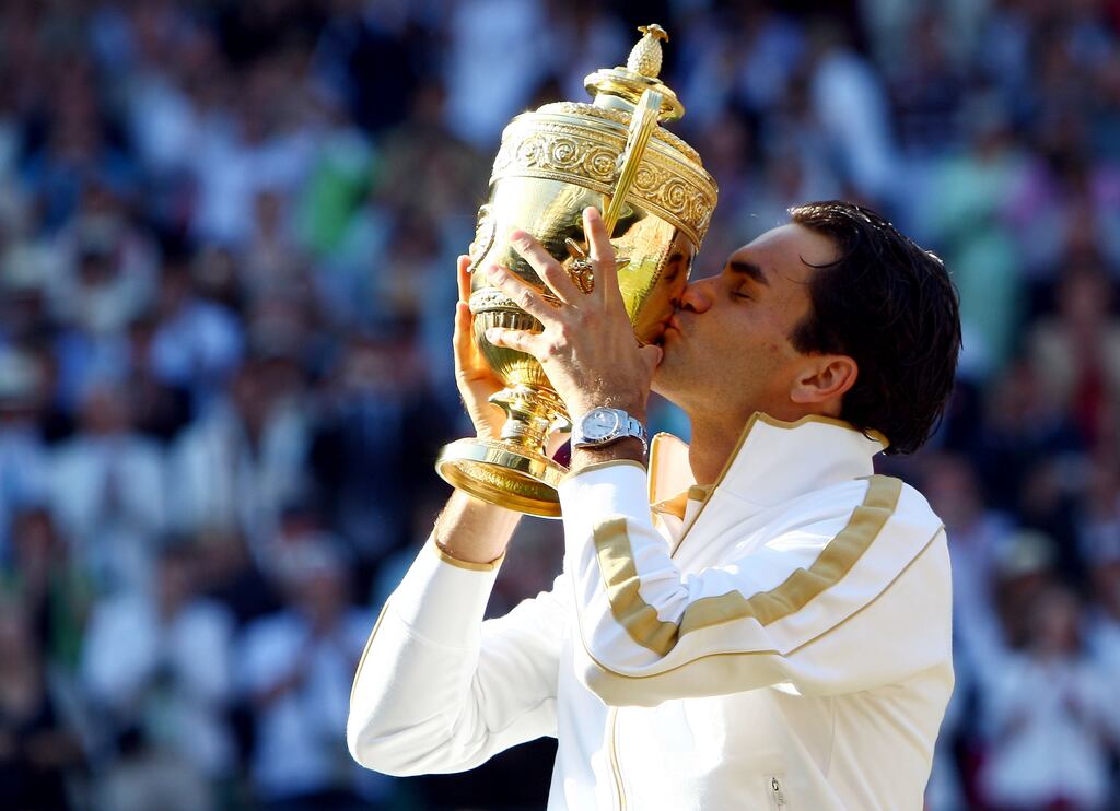 Roger Federer of Switzerland kisses the Wimbledon trophy after beating Andy Roddick in 2009. Photograph: Clive Brunskill/Getty