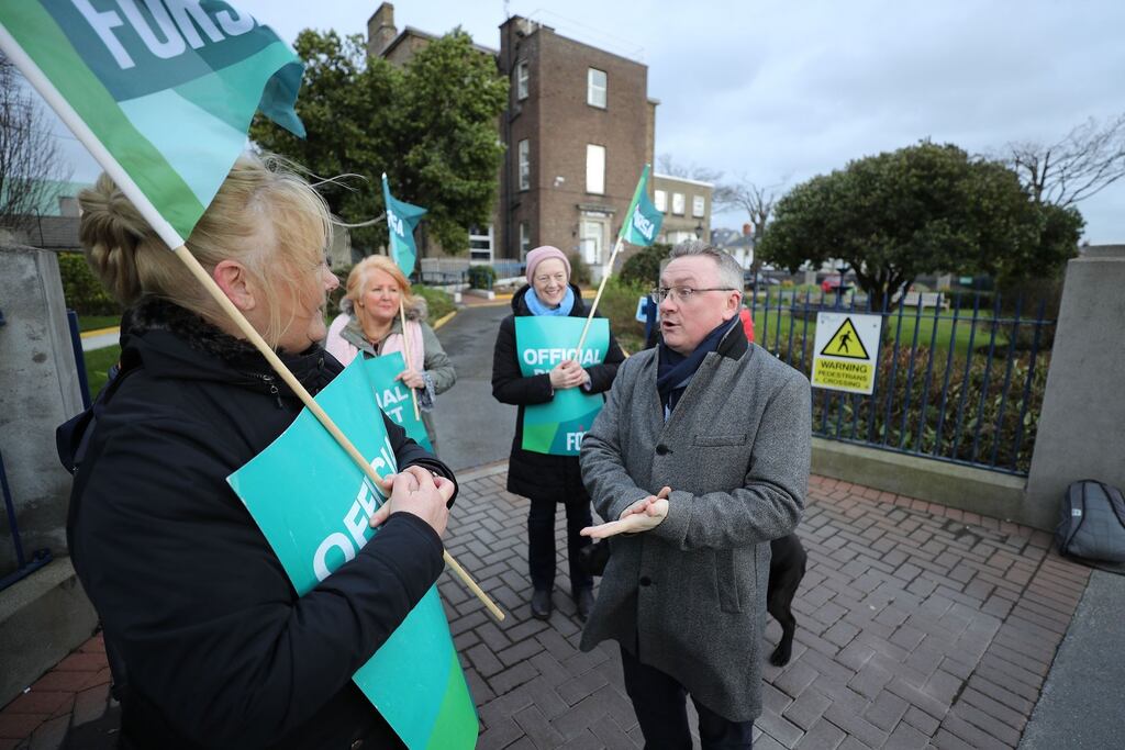 Chris White (right), CEO of the NCBI, speaks to demonstrators at the strike on Whitworth Road in Dublin on Friday. Photograph Nick Bradshaw for The Irish Times