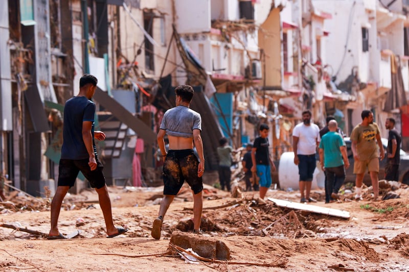 People walk among the debris and destruction in Derna. Photograph: AFP via Getty
