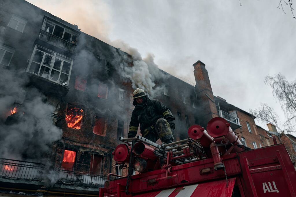 Emergency workers put out a fire after Russian shelling hit an apartment building in Bakhmut, Donetsk region, Ukraine. Photograph: Libkos/AP