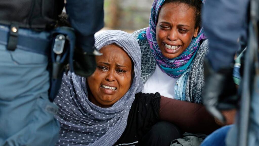 African migrants become upset as Italian police attempt to remove them at the Franco-Italian border between Menton and Ventimiglia during June 2015. Photograph: Sebastien Nogier/EPA