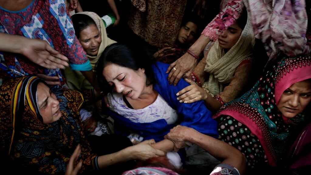 Women try to comfort a mother w hose son son was killed in the public park bomb attack in Lahore in Pakistan on Sunday. Photograph: KM Chaudary/AP