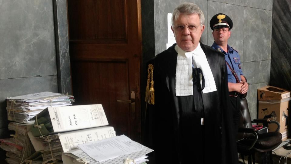 Silvio Berlusconi’s defence lawyer, Longo, poses at court before the start of Berlusconi’s trial in Milan. Photograph: Alessandro Garofalo/Reuters