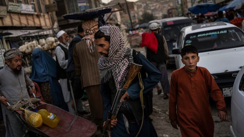 Taliban fighters patrol a market in Kabul’s Old City. Photograph: Bernat Armangue/AP