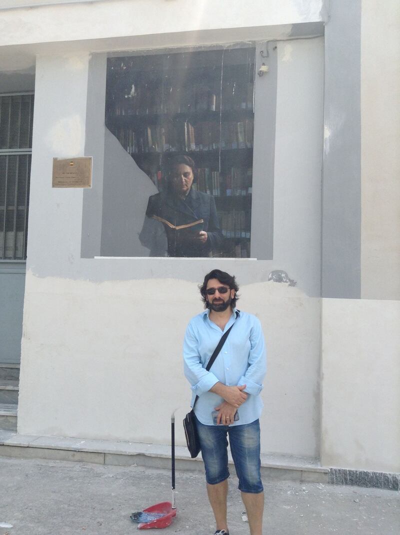 Maurizio Pagano outside the library featyured in the novels. It now carries a mural featuring one of the characters from the TV adaption.