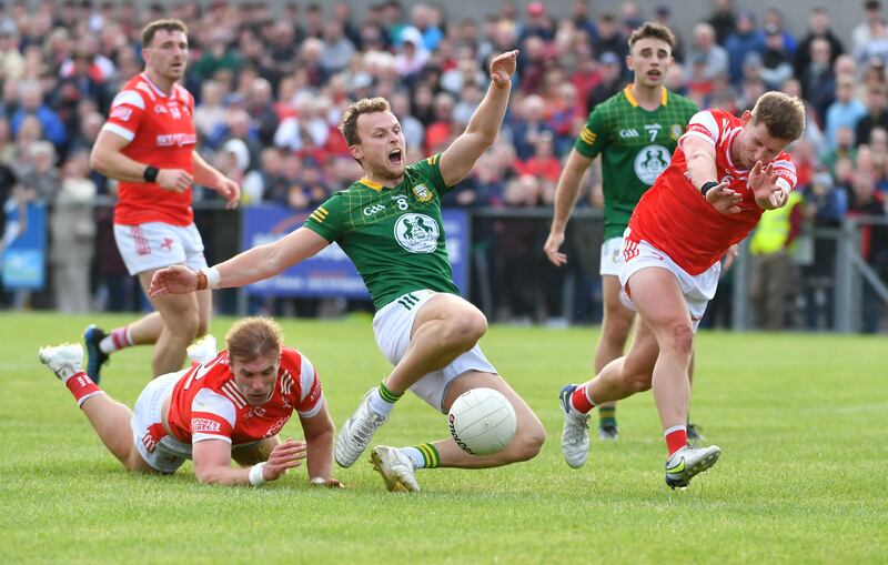 Ronan Jones of Meath is tackled by Conor Grimes of Louth as he was going for a score. Photograph: Inpho