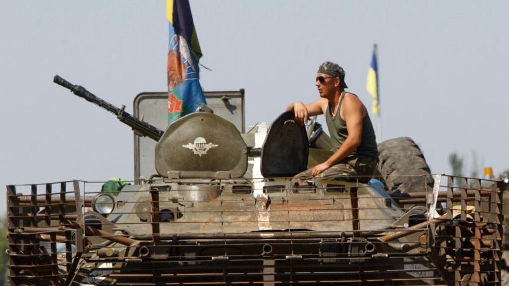 A Ukrainian serviceman sits on a military armoured vehicle near Donetsk today. Ukraine said it had headed off an attempt by Russia to send troops into Ukraine under the guise of peacekeepers with the aim of provoking a large-scale military conflict, a statement Moscow dismissed as a ‘fairy tale’. Photograph: Reuters
