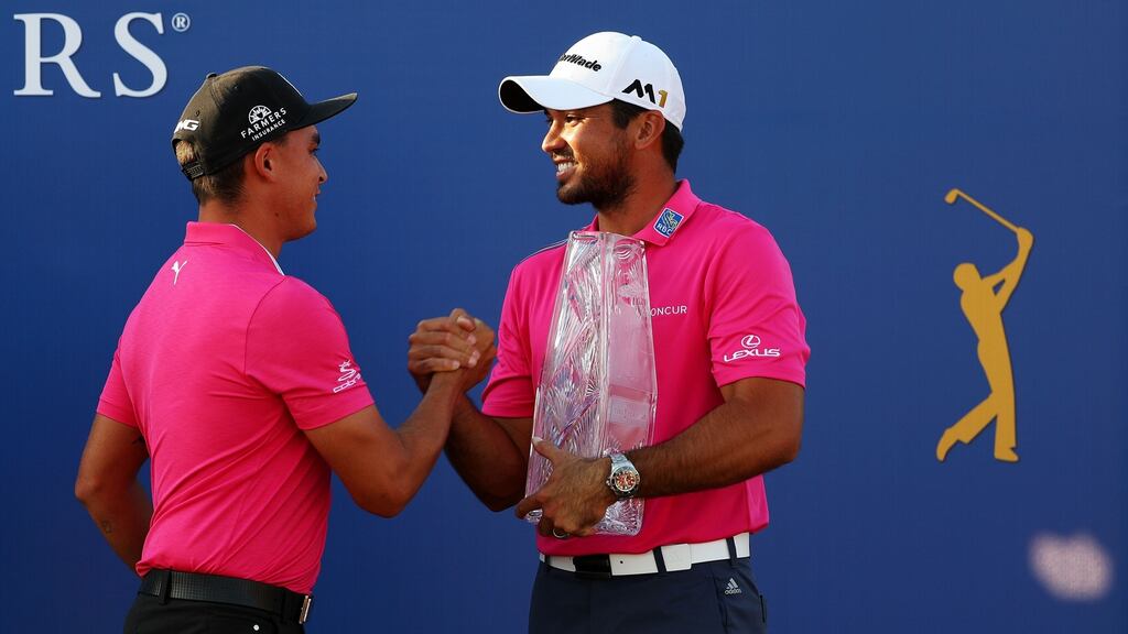 Rickie Fowler of the United States presents the trophy to Jason Day of Australia after Day won the final round of The Players Championship at the Stadium course at TPC Sawgrass in Ponte Vedra Beach, Florida. Photograph: Mike Ehrmann/Getty Images