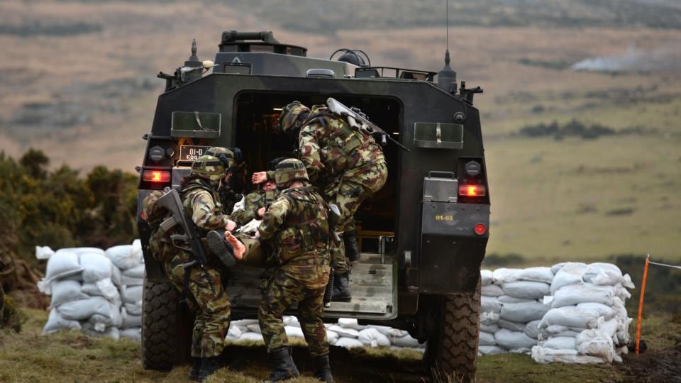 Training: members of the 48th Infantry Group lift an injured colleague into a Mowag at Camp Coolmoney, in the Glen of Imaal, before departing for UN duty in Syria. Photograph: Dara Mac Dónaill