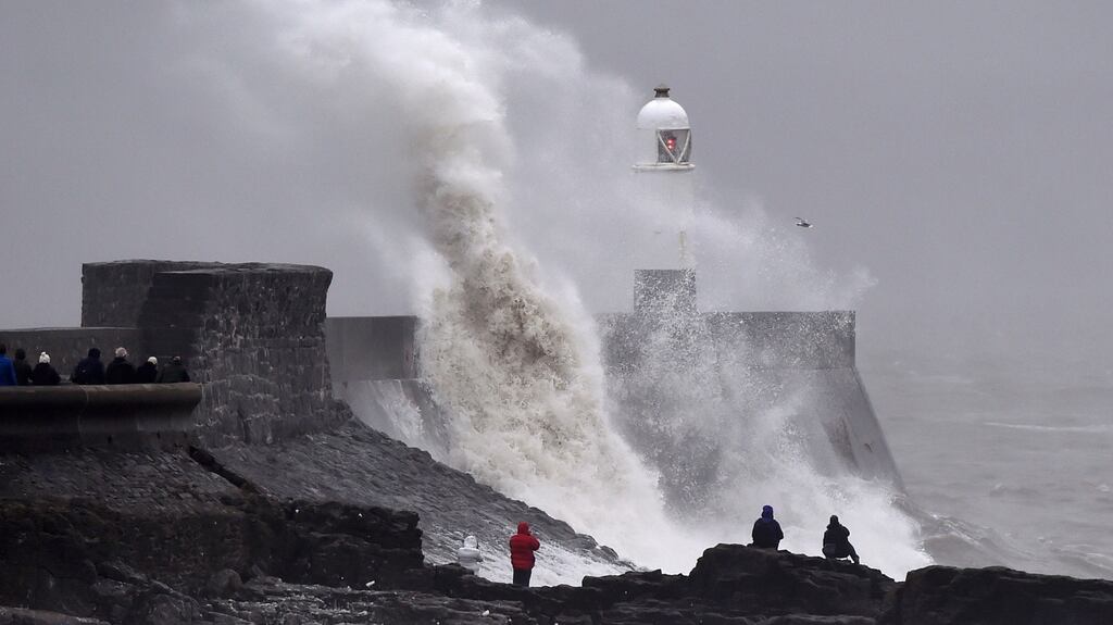 Waves crash over the lighthouse at Porthcawl, Wales, February 1, 2016. Gale force winds are affecting parts of Wales. REUTERS/Rebecca Naden