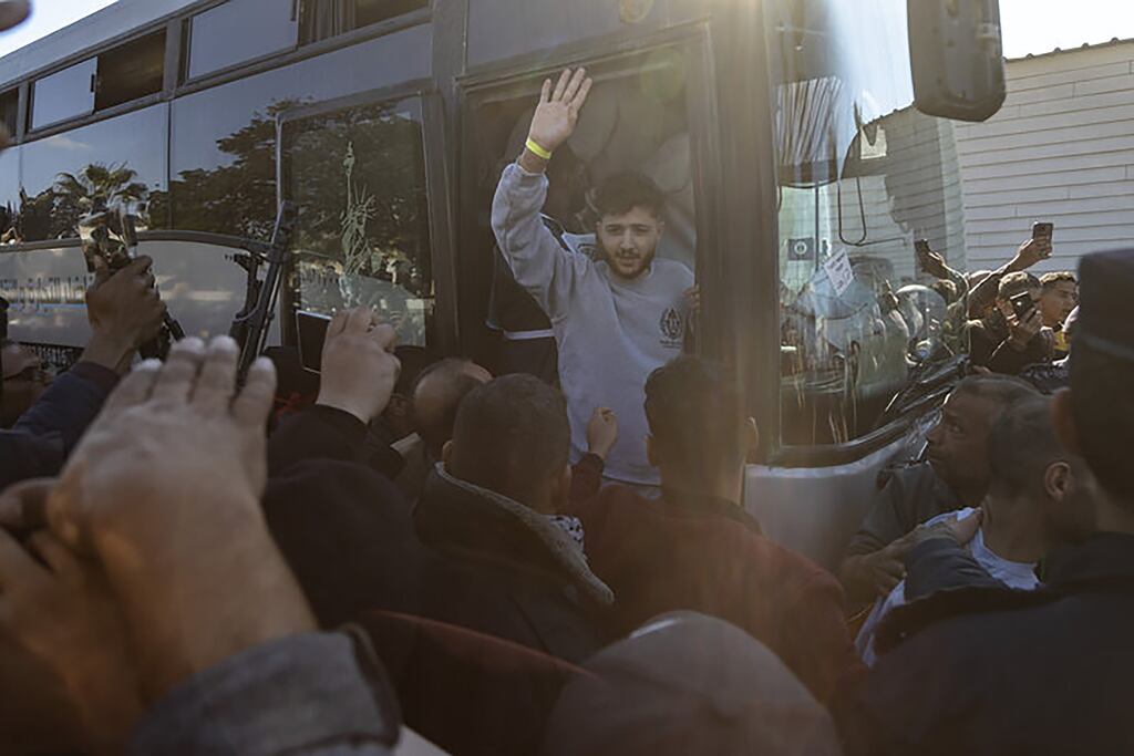 A Palestinian prisoner released by Israel greets family and supporters after arriving by bus in Khan Younis, in the southern Gaza Strip. Photograph: Khan Younis/New York Times