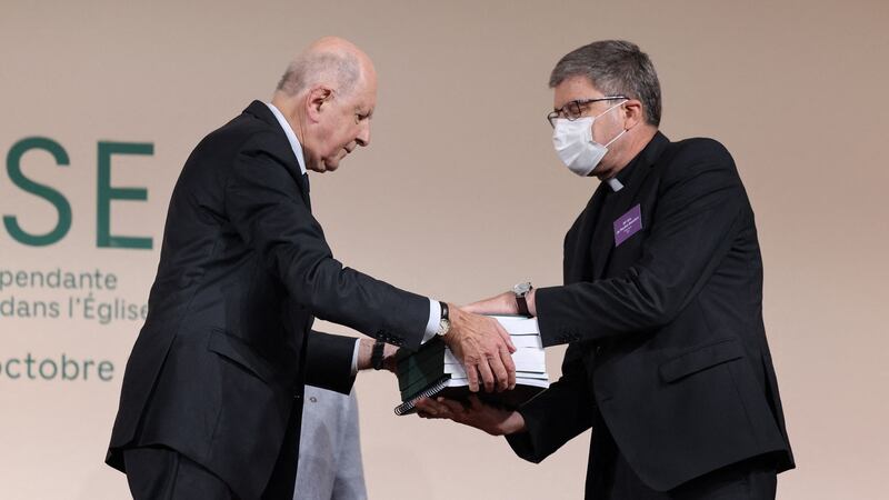 Commission president Jean-Marc Sauve (L), hands copies of the report to Catholic Bishop Eric de Moulins-Beaufort, president of the Bishops’ Conference of France. Photograph: Thomas Coex/ Pool/AFP via Getty Images