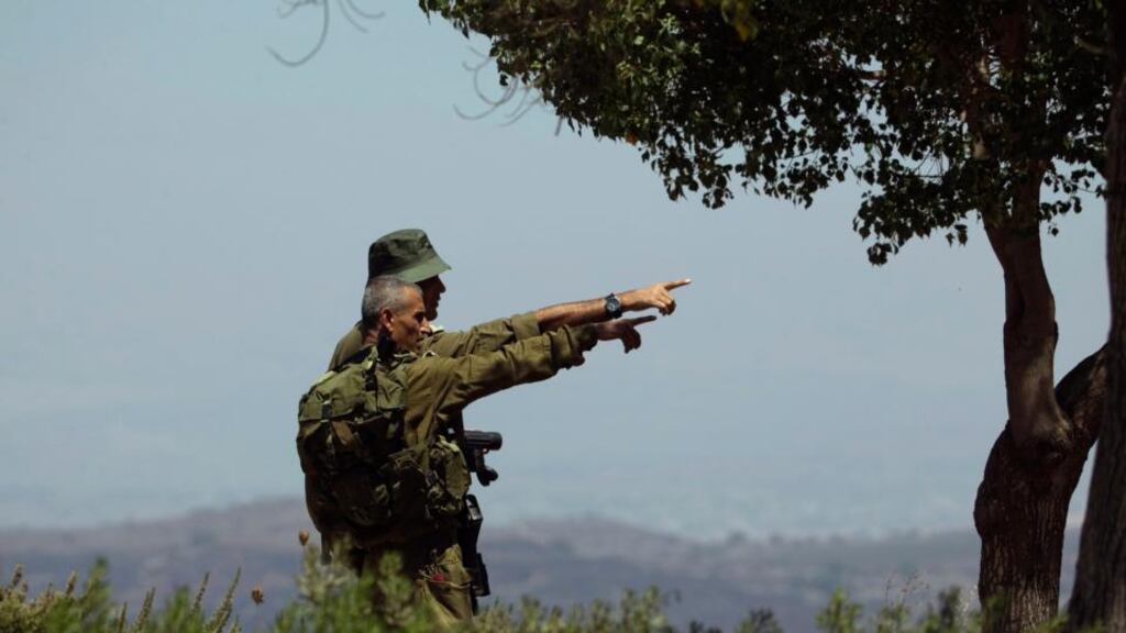 Israeli soldiers observe the Syrian side of the Quneitra border crossing between the Israeli-controlled Golan Heights and Syria yesterday. Photograph: Reuters