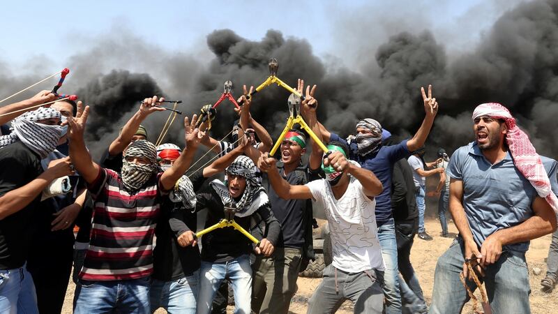 Palestinian demonstrators, some brandishing wire-cutters, gesticulate during a protest demanding the right of return at the Israel-Gaza border in the southern Gaza Strip, on Friday. Photograph: Ibraheem Abu Mustafa/Reuters
