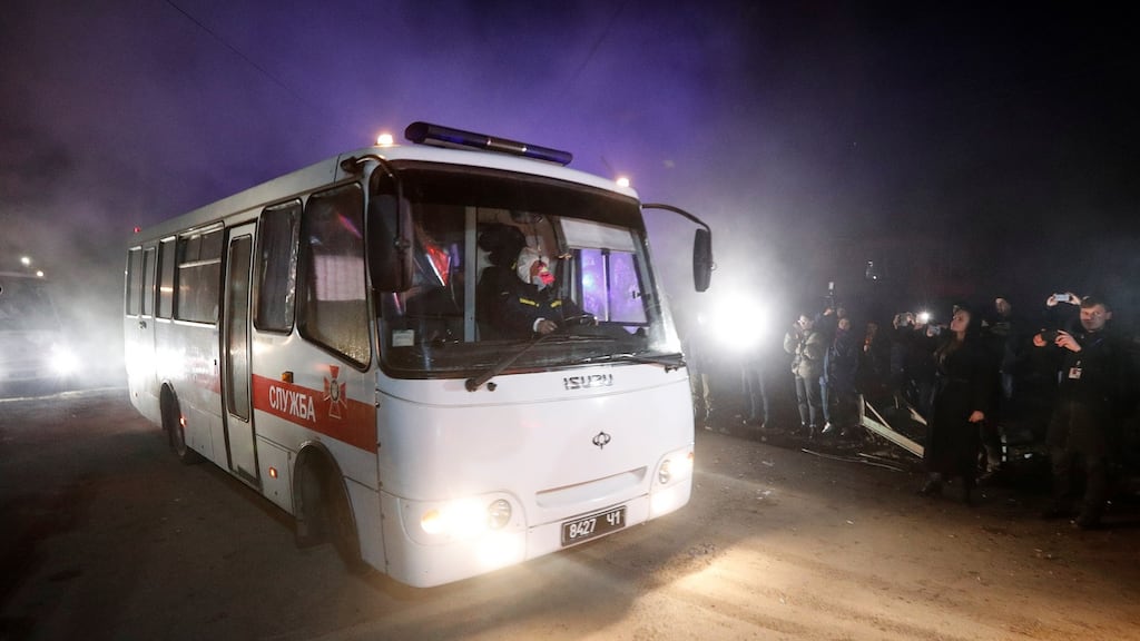 Buses transporting evacuees from coronavirus-hit China’s Hubei province drive past demonstrators during a protest against their arrival. Photograph: Vlaentyn Ogirenko/Reuters