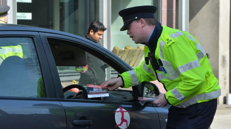 Gardaí at Haddington Road put up posters and give out leaflets in April 2017  highlighting the €100,000 reward for information relating to Trevor Deely’s disappearance. File photograph: Alan Betson/The Irish Times