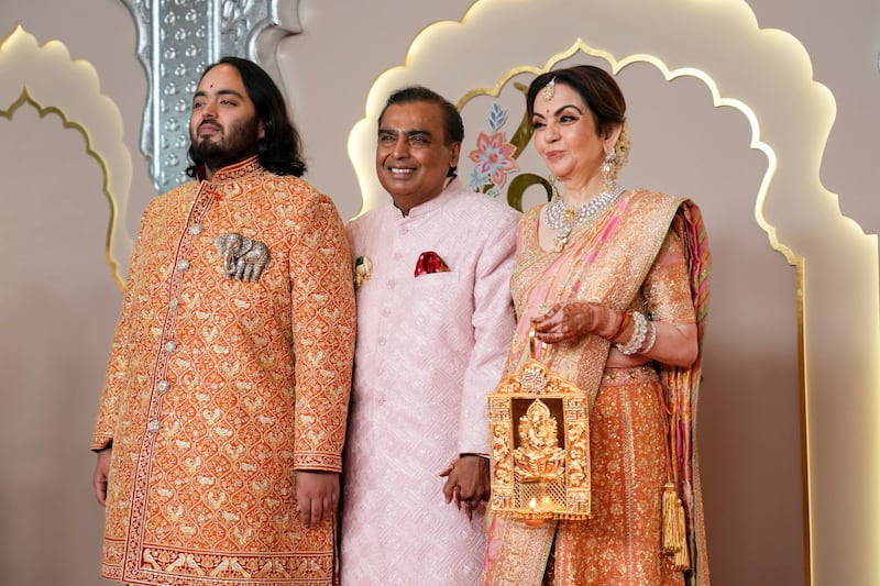 Billionaire Mukesh Ambani with wife Nita and son Anant. Photograph: Rajanish Kakade/AP