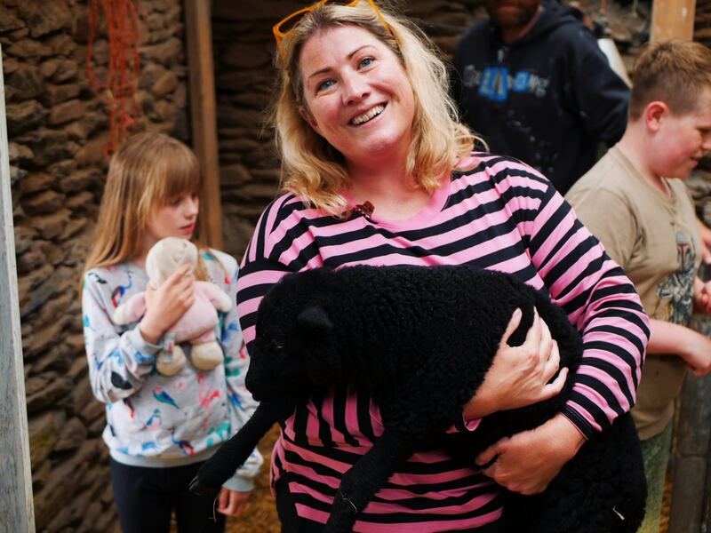 Ali Dunworth holding a baby lamb