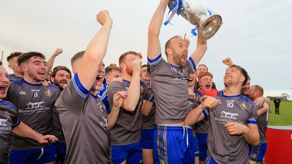 Naomh Mairtin players celebrates after the game with the Joe Ward trophy. Photograph: Inpho