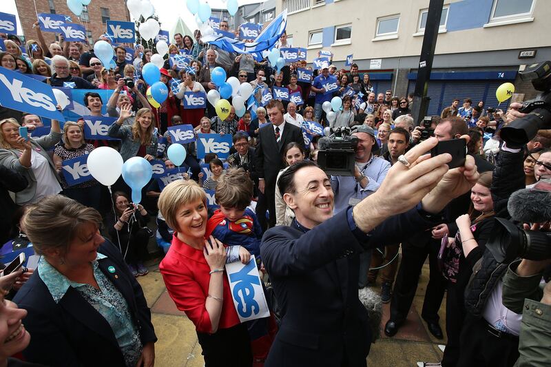 Cumming, a supporter of Scottish independence, takes a selfie with Nicola Sturgeon while campaigning in Glasgow in 2014. Photograph: Jeremy Sutton-Hibbert/Getty Images