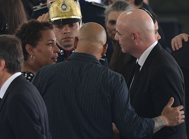 FIFA president Gianni Infantino speaks with sons of Brazilian football legend Pele, Kelly Cristina and Edinho during Pele's wake at the Urbano Caldeira stadium in Santos. Photograph: Carl de Souza/AFP via Getty