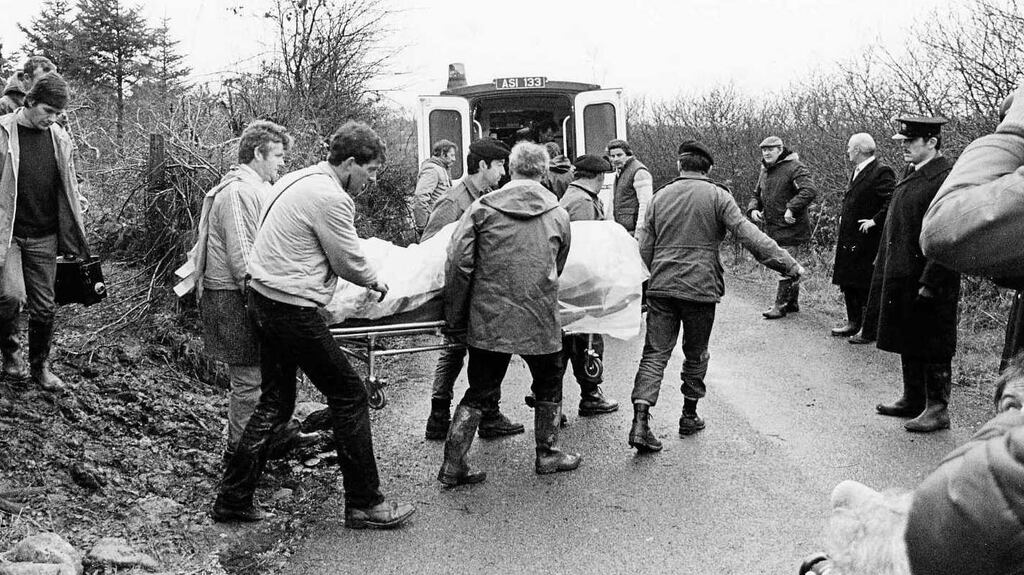 The bodies of Pte Patrick Kelly and Garda Peter Gary Sheehan are removed from woodlands in Leitrim: David Kelly says his father deserves justice for the sacrifice he made for the State. Photograph: Pat Langan