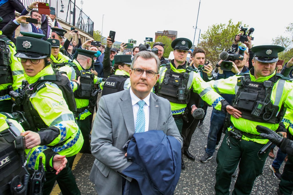 Former DUP  leader  Jeffrey Donaldson is surrounded by PSNI officers  after appearing in court in Newry on April 24th charged with sex offences. Photograph: Paul Faith/AFP