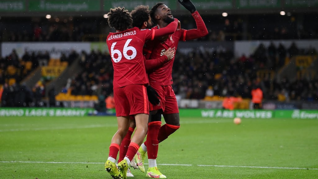 Divock Origi  celebrates with Liverpool team-mates Trent Alexander-Arnold and Mohamed Salah after scoring his side’s late winner against Wolves at  Molineux. Photograph:  Laurence Griffiths/Getty Images