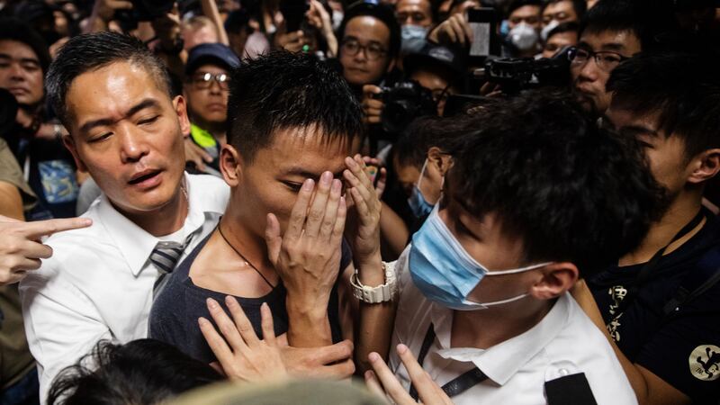 A man alleged to be a mainland police officer is surrounded by security officials and protesters at the Hong Kong International Airport in Hong Kong, China. Photograph: Kyle Lam/Bloomberg