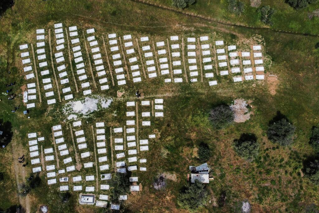 Tombs at the newly renovated cemetery dedicated to refugees drowned while trying to cross to Europe in the Aegean sea, near Kato Tritos village on the Greek island of Lesbos. Photograph: Manolis Lagoutaris/AFP via Getty Images