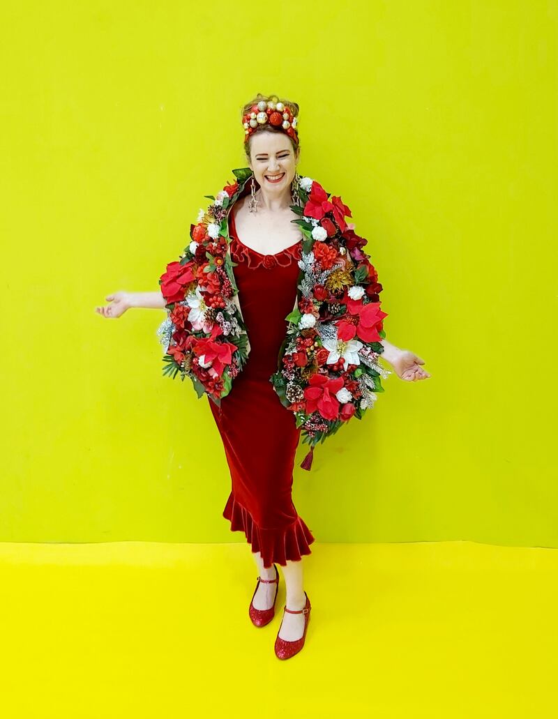 Taryn de Vere wearing a red velvet dress. Her hairband, wrap and jewellery she made herself